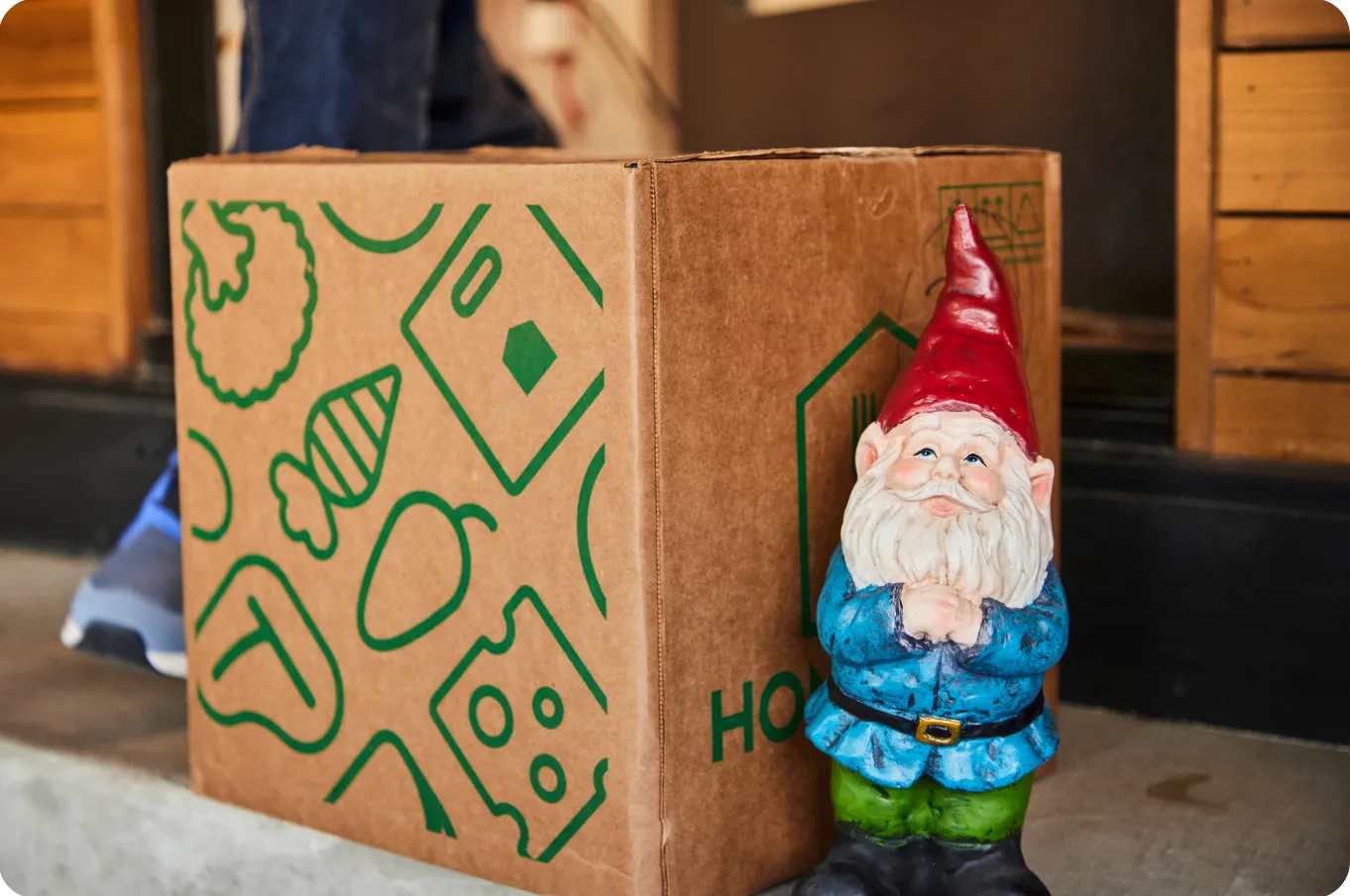 A cardboard box and a mini Santa Clause toy.