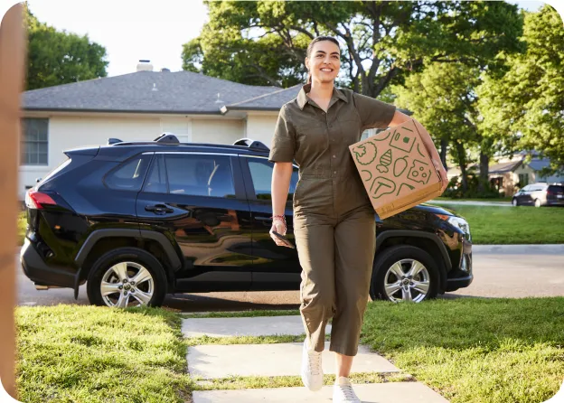A female Veho driver delivering a box to the customers house. 