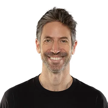 Smiling man with short dark hair and beard wearing a black shirt against a white background.